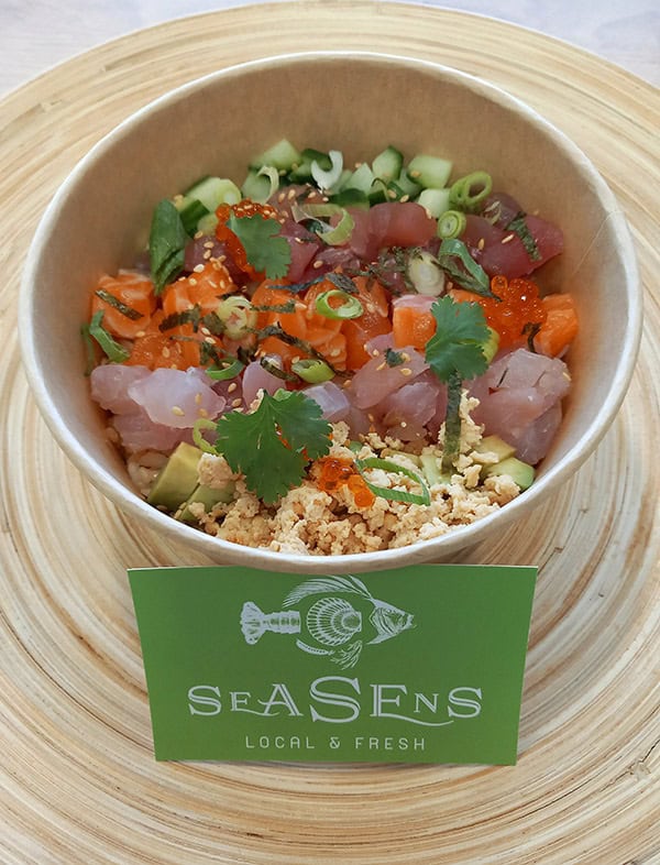 Un bol de tartare de poisson avec légumes frais, œufs de poisson, coriandre et herbes. Parfait pour découvrir la cuisine marine locale de SeaSens, traiteur spécialisé en fruits de mer à Lorient.